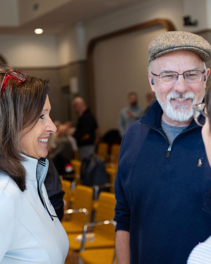 An investor and a founder in conversation at the annual meeting